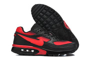 Pair of black and red Nike Air Max sneakers showing the side profile and tread outsole.