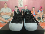 Front view of the sneakers showing black laces, padded tongues, white toe sections, and translucent-looking outsoles.