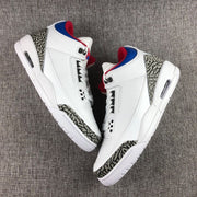 Overhead side view showing both sneakers, white midsoles and elephant-print panels.