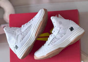 Pair of white mesh high-top shoes displayed at an angle