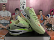 Angled side view showing the textured upper, black swoosh, green trim, layered sole, and heel branding.