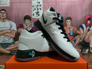 Angled view of the white and black basketball shoes showing the Swoosh, lacing, and heel support.
