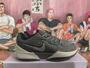 Gray and black Nike basketball sneaker shown in profile on a shoebox.