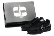Black sneaker pair shown beside a black box marked Sabrina, with white side logos and mint-green tongue details visible.