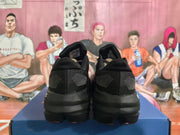 Pair of black running shoes shown from the rear with patterned heel panels.