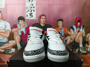 Front view of the sneakers with patterned toe overlays and Jordan-branded tongues.