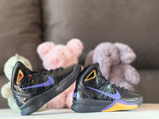 Side view of the pair highlighting purple swoosh-shaped details and gold midsole panels
