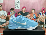 Side view of a blue Nike basketball shoe with a white Swoosh, laces, and white outsole.