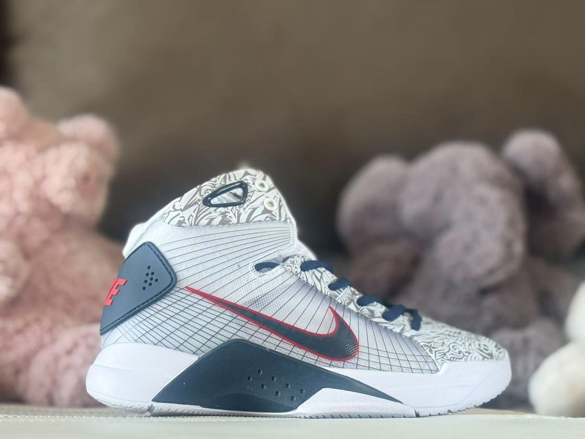 Side view of a white and gray high-top basketball shoe with navy and red accents and graphic panels