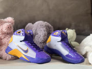 Angled view of the pair highlighting the high collars, laces, patterned side panels, and gold side accents.