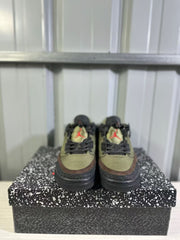 Front view of the pair showing matching green toe boxes, brown trim, black laces, and red tongue logos.