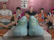 Front view of the light blue lace-up basketball sneakers with textured uppers and padded collars.