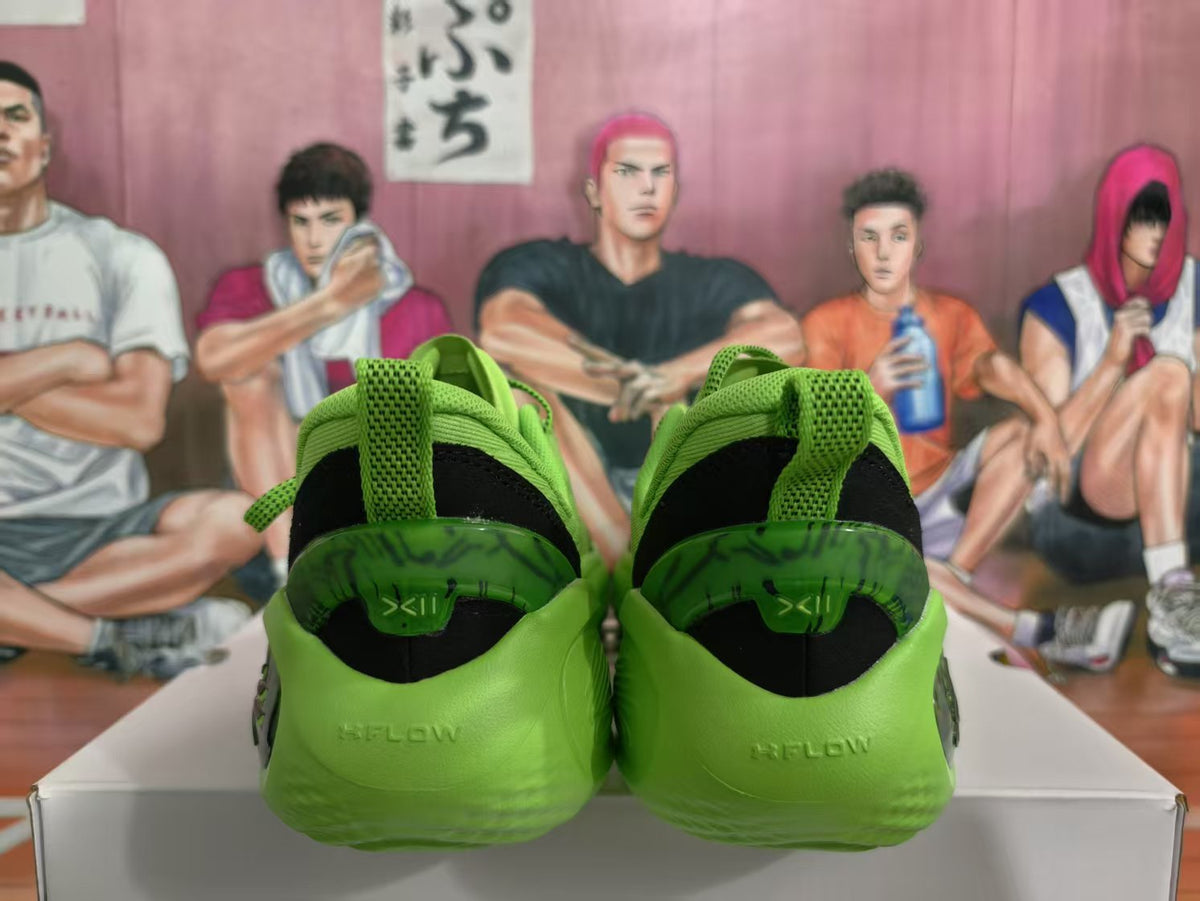 Rear view of bright green basketball sneakers with black heel panels and green pull tabs.