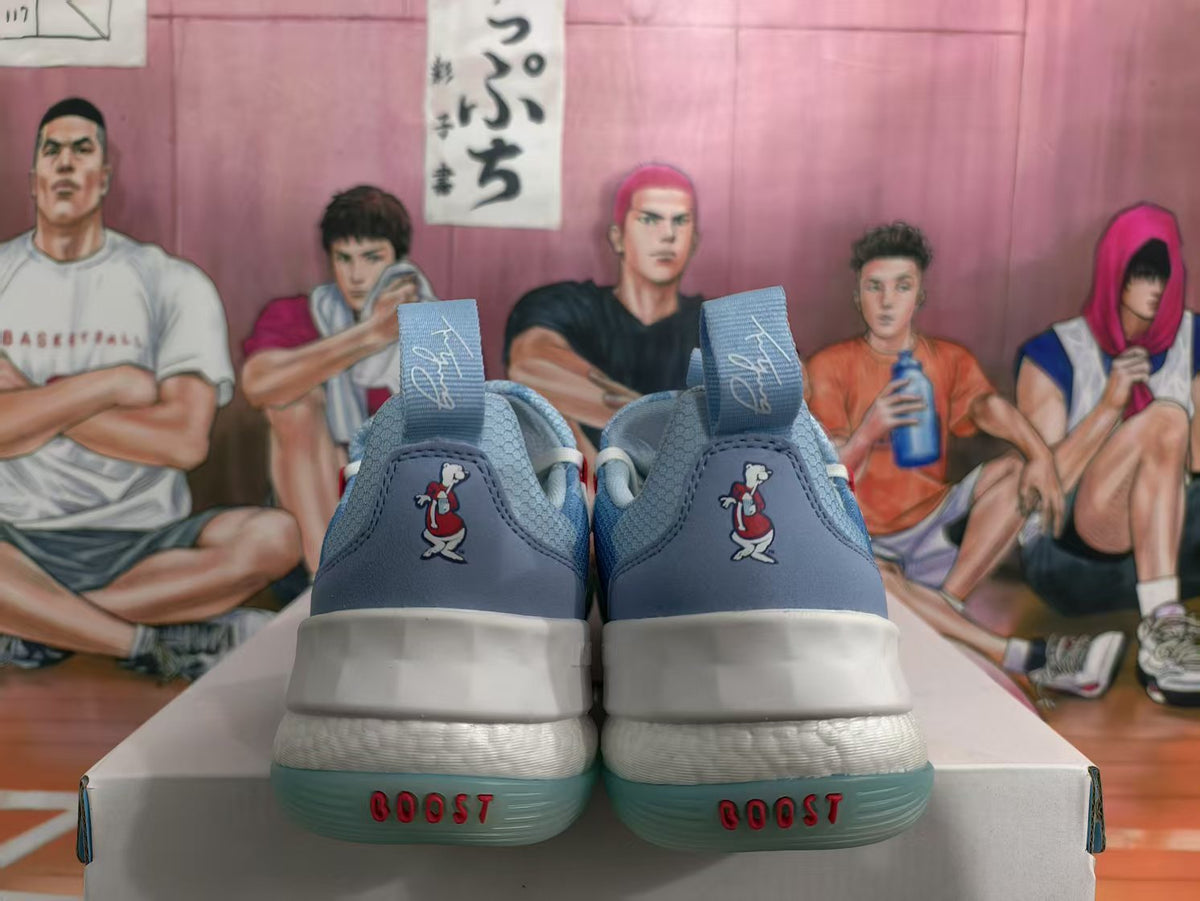 Rear view of blue basketball sneakers showing padded collars, heel pull tabs, white midsoles, and translucent blue-green outsoles.