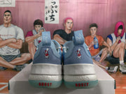 Rear view of blue basketball sneakers showing padded collars, heel pull tabs, white midsoles, and translucent blue-green outsoles.