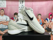 Angled view of the pair highlighting the black Swoosh, textured uppers, and layered white sole.