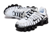 Angled view of the white, silver, and black Nike Shox TL sneakers.