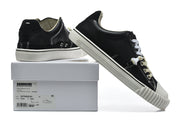 Black low-top sneaker displayed with its box; the box label shows a sample size of 41.