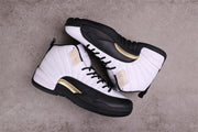 Overhead view of a pair of white, black, and gold Air Jordan 12 sneakers