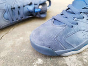 Detailed view of the perforated blue toe box and stitched upper panels.