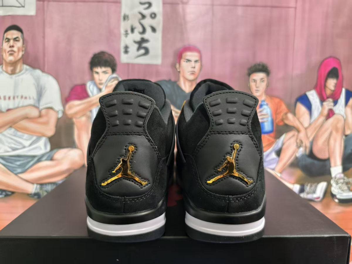 Rear view of black sneakers with gold-toned Jumpman logos and white-and-black midsoles.