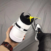 Rear view showing the white heel, black collar, and contrasting horizontal panel.