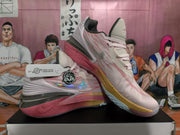 Angled view of two pink and light-colored Nike basketball sneakers showing the side branding, heel structure, and contrasting outsole.