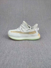 Side profile of the sneaker showing the low-top shape, tan stripe, and translucent-looking outsole.