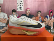 Side view highlighting the black Swoosh, pale yellow trim, and coral sole of a white Nike running shoe.