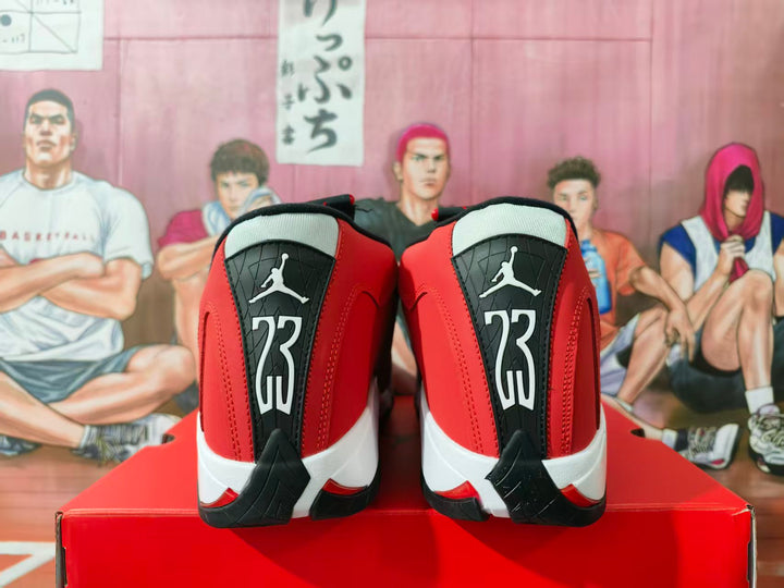 Rear view of red and black high-top basketball sneakers with white midsoles, black heel panels, and visible Jumpman branding.