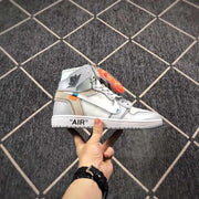 Side profile of one high-top sneaker showing the winged collar logo, grey heel panel and quoted AIR midsole text.