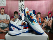 Angled view of white and blue basketball shoes showing colorful side artwork and blue accents.