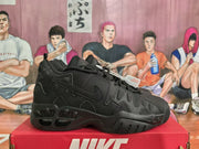 Side view of black Nike sneakers highlighting the layered upper and chunky sole.