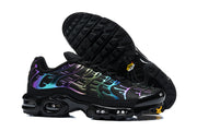 Black Nike Air Max Plus sneakers shown from the side and underside, with multicolor iridescent-style overlays.