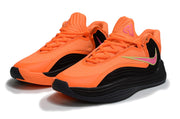 Pair of orange and black Nike Giannis Immortality 7 basketball shoes