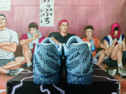 Rear view of the blue and silver basketball sneakers showing the padded collars, heel details and textured outsole.