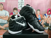 Angled view of the paired black high-top sneakers, showing the sculpted side panels, white Swoosh and white outsoles.