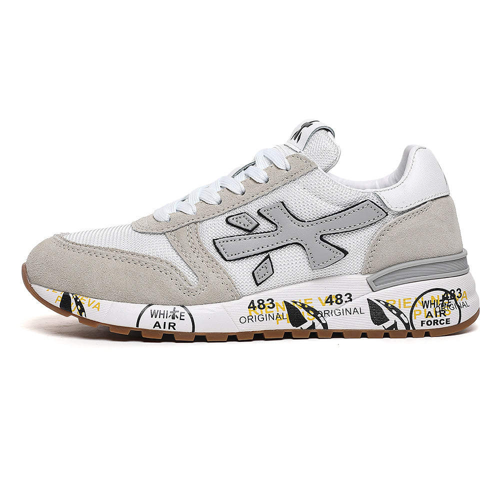 Side view of a white and grey low-top sneaker with beige overlays, a large side logo and a gum-colored outsole.