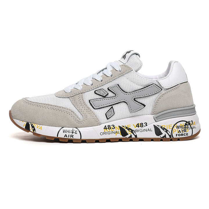 Side view of a white and grey low-top sneaker with beige overlays, a large side logo and a gum-colored outsole.