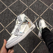 Angled view of a grey and white high-top sneaker showing the side panel, laces and printed details.