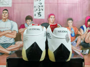 Rear view of white Jordan shoes with black heel accents and Air Jordan lettering.