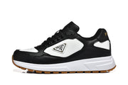 Side view of a black and white low-top sneaker with a triangular logo plaque