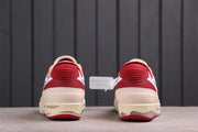 Rear view showing red heel details, cream midsoles, and gray-red outsole edges.