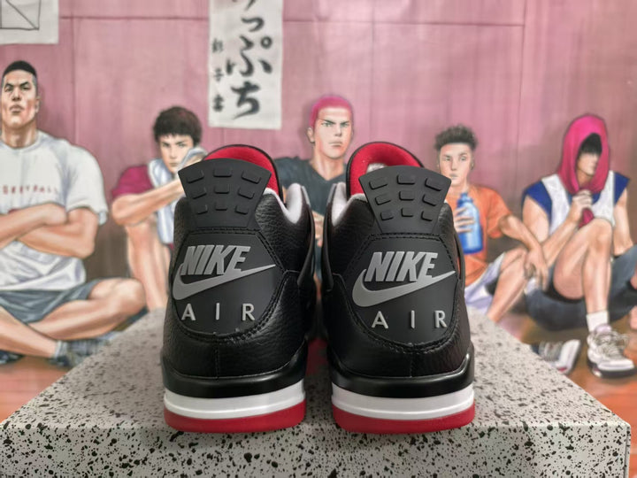 Rear view of black and red high-top sneakers showing Nike Air heel branding and layered red, white, grey, and black soles.