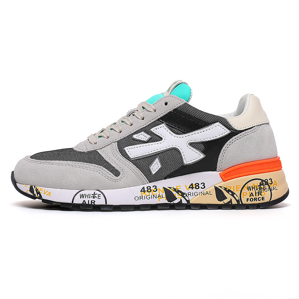 Gray, black and white low-top sneaker with a white side logo, orange heel detail, turquoise tongue accent and printed sole