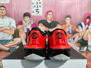 Rear view of the red and black shoes with GT heel marks and light-colored outsole sections.
