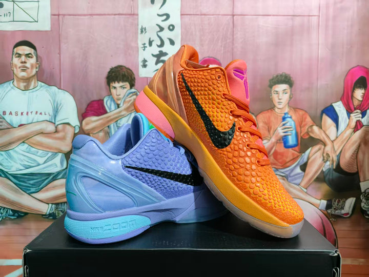 Ice-blue and orange Nike basketball sneakers displayed together on a black box.