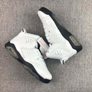 Top and side view of the white and black high-top sneakers with perforated panels and sculpted midsoles.
