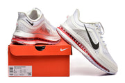 White and gray Nike Pegasus Premium shoes with black Swoosh details and red cushioning, displayed on an orange shoe box.