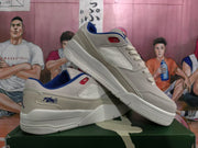 Angled view of the pair displaying the low-top profile, lace-up construction, blue lining, and white outsole.